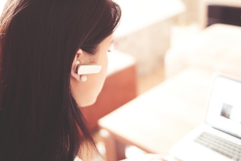 woman using ada compliant website with headphone